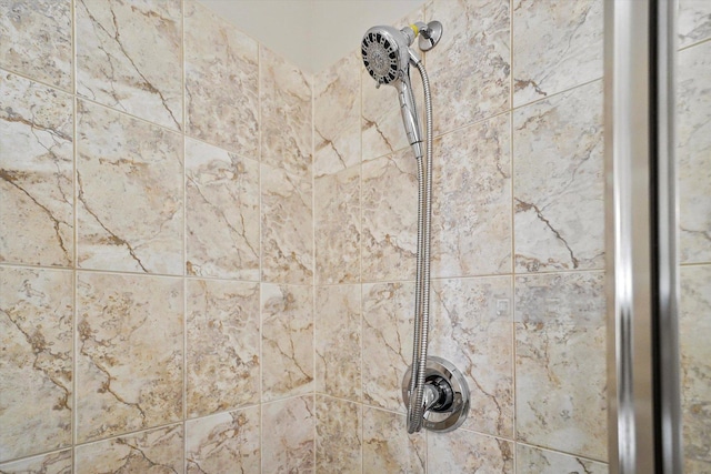 interior details featuring tiled shower