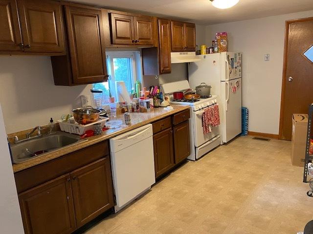 kitchen with sink and white appliances