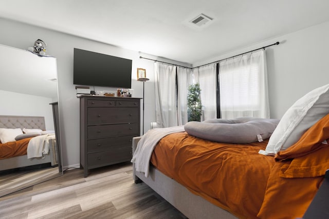 bedroom with light hardwood / wood-style flooring