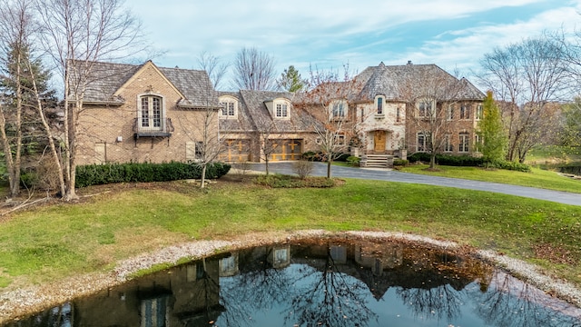 french country inspired facade with a front yard