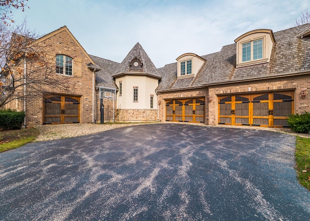 french country home with a garage