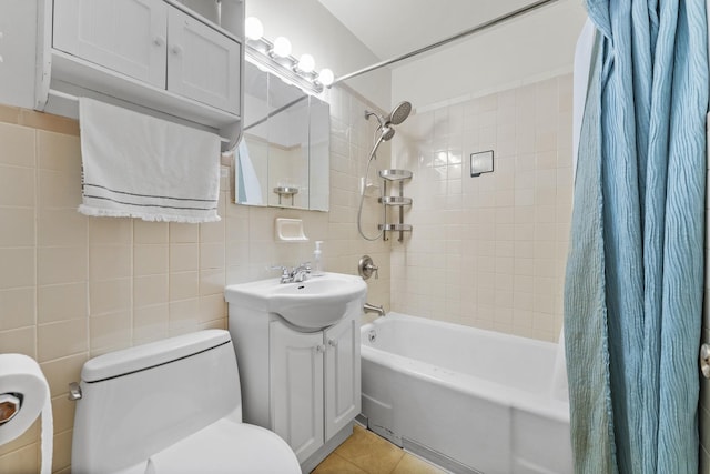 full bathroom featuring toilet, tile patterned flooring, shower / bath combination with curtain, tile walls, and vanity