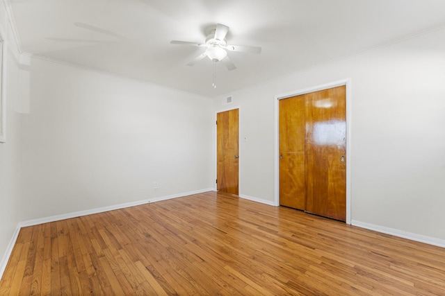 empty room with light hardwood / wood-style floors, ceiling fan, and crown molding