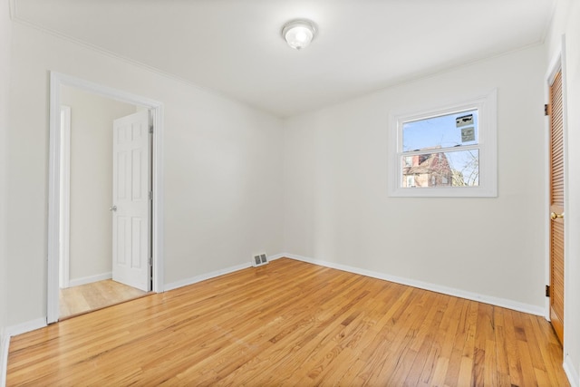 interior space featuring crown molding and light hardwood / wood-style flooring