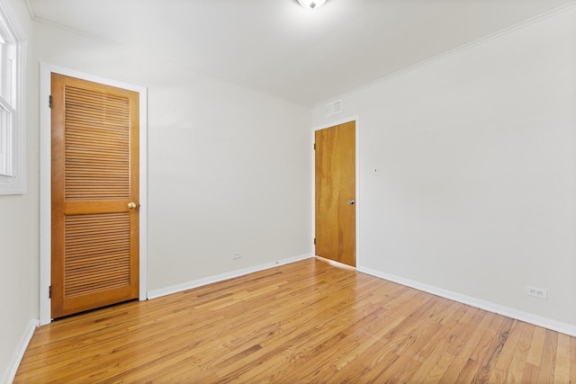 spare room with light hardwood / wood-style flooring