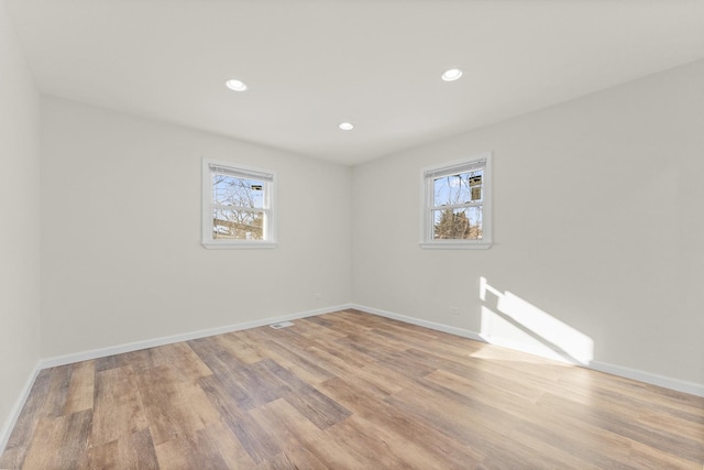 empty room featuring light hardwood / wood-style floors and a wealth of natural light