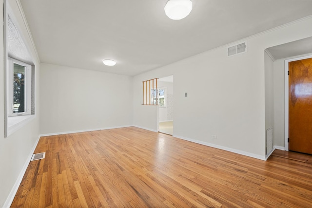 empty room with light hardwood / wood-style flooring