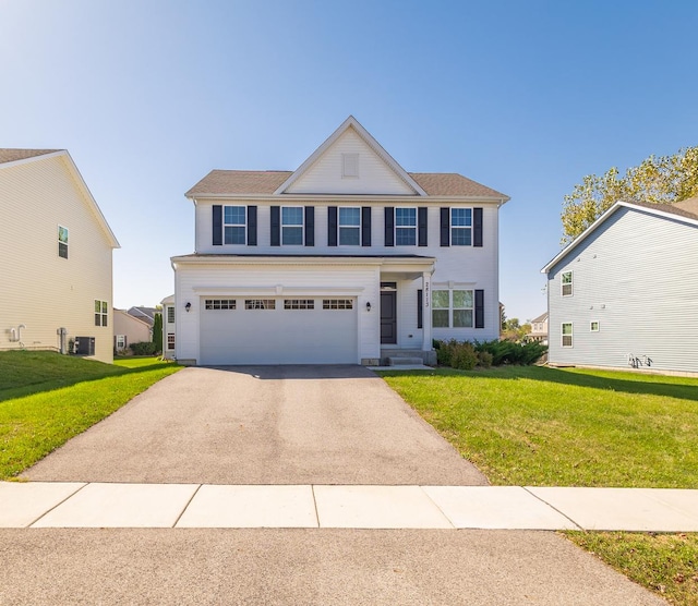 view of front facade with central AC, a front yard, and a garage