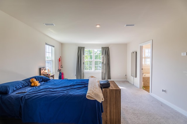 carpeted bedroom with ensuite bathroom