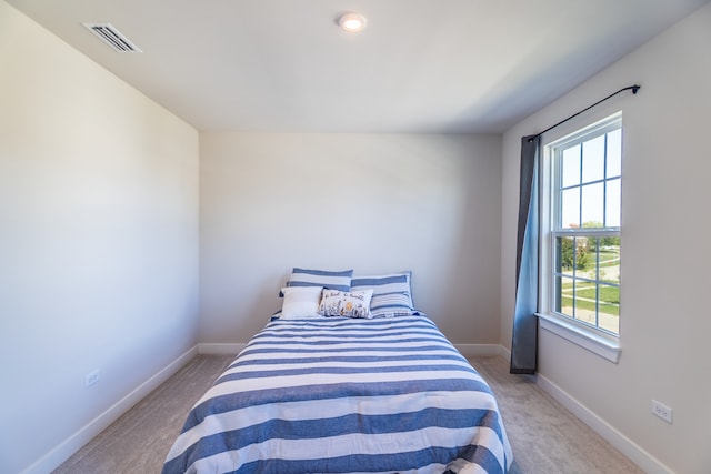 bedroom featuring light carpet