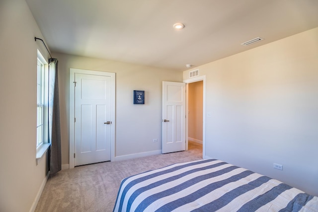 carpeted bedroom featuring multiple windows