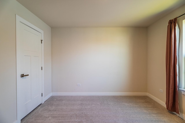 unfurnished room with light colored carpet