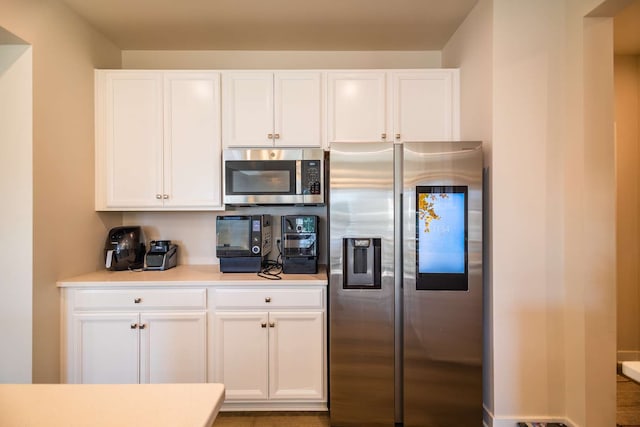 kitchen with stainless steel appliances and white cabinetry