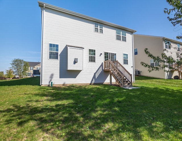 back of house with a lawn and central AC