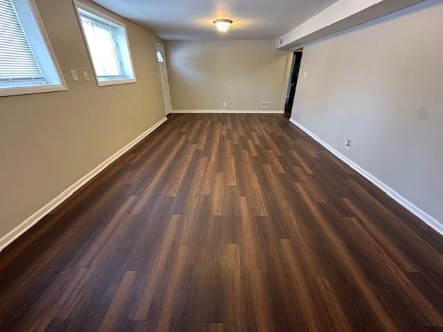 basement featuring dark hardwood / wood-style flooring