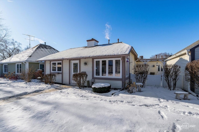 view of snow covered rear of property