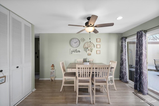 dining space with ceiling fan and wood-type flooring