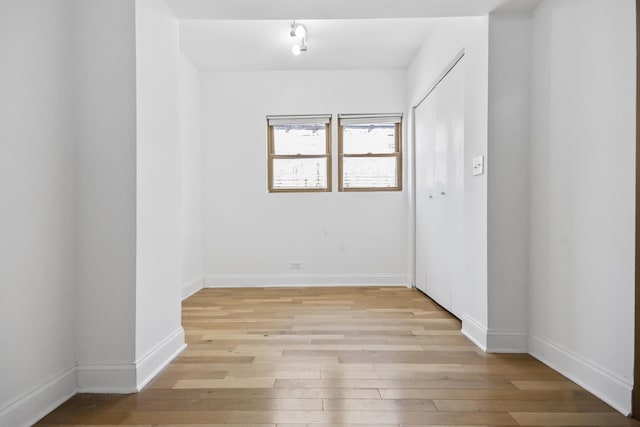 empty room with light hardwood / wood-style flooring