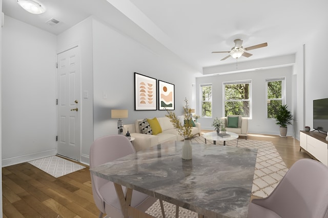 dining area featuring ceiling fan and dark hardwood / wood-style floors