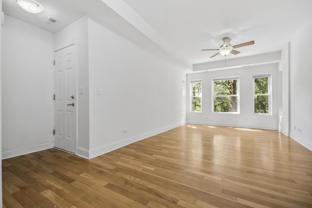 unfurnished living room featuring ceiling fan and hardwood / wood-style flooring