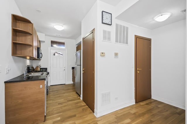 corridor featuring hardwood / wood-style floors and sink