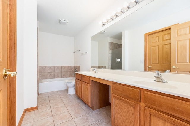 bathroom with toilet, a washtub, vanity, and tile patterned floors