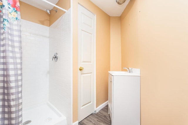 bathroom featuring sink, walk in shower, and hardwood / wood-style floors