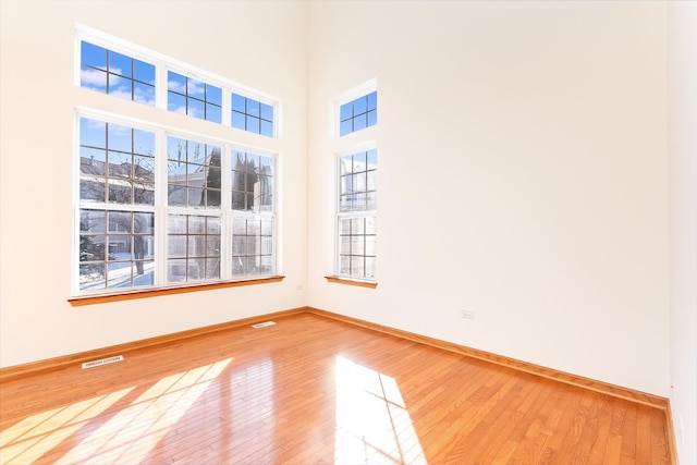 empty room with hardwood / wood-style floors