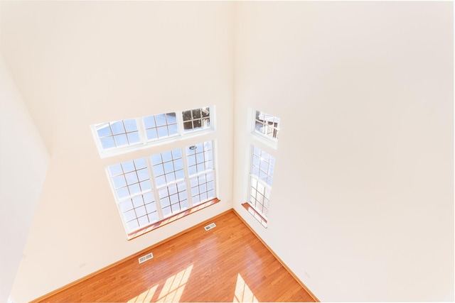 unfurnished room with hardwood / wood-style flooring