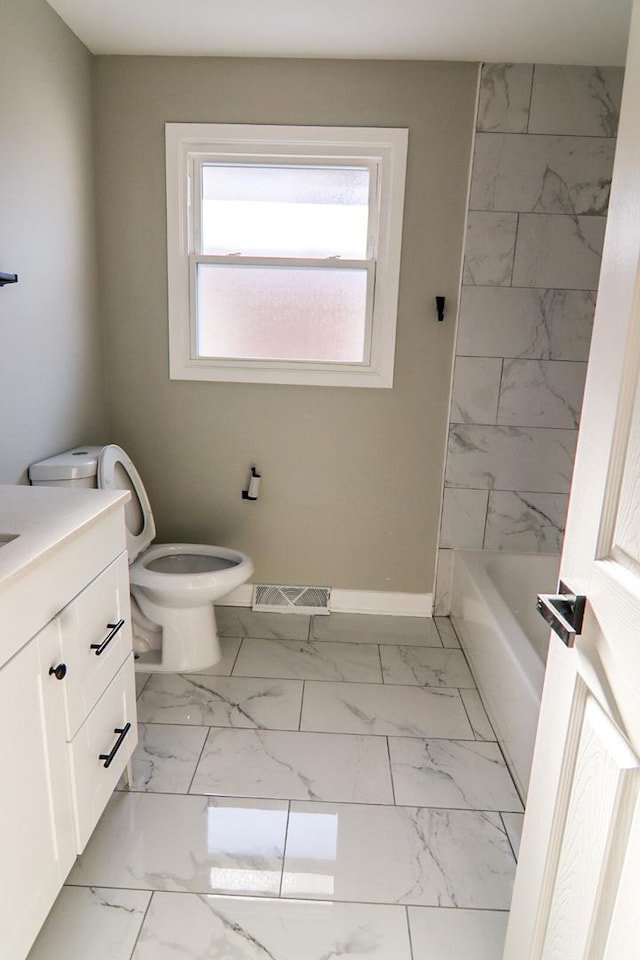 bathroom featuring toilet and vanity