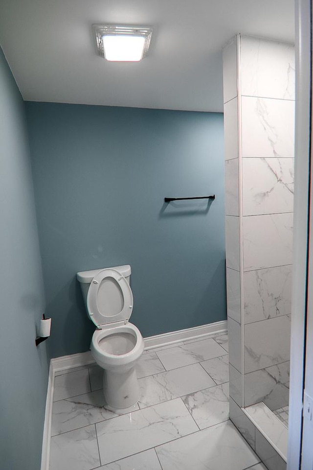 bathroom featuring walk in shower and toilet