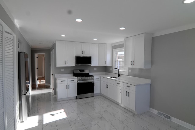 kitchen featuring stainless steel appliances, white cabinets, and sink