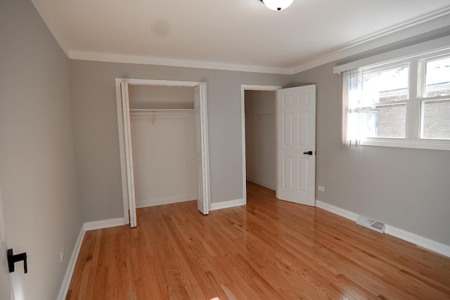 unfurnished bedroom with light hardwood / wood-style floors and ornamental molding