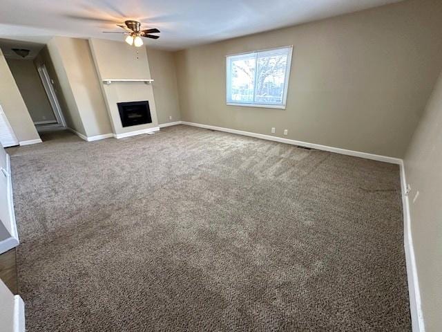 unfurnished living room featuring carpet flooring and ceiling fan