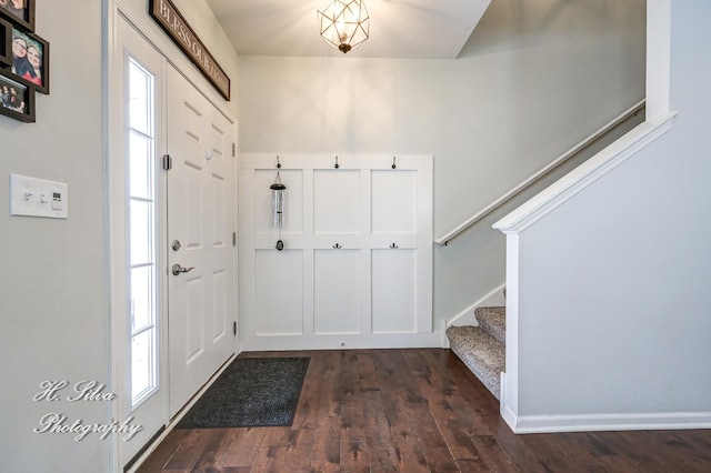 foyer entrance featuring a wealth of natural light and dark wood-type flooring