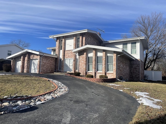 view of front of house with a garage and a front lawn