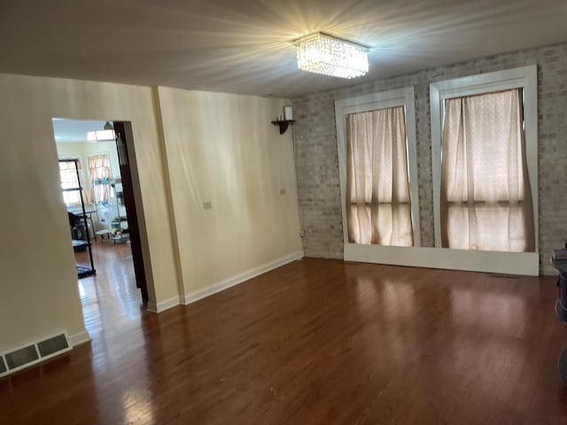 empty room with dark hardwood / wood-style floors