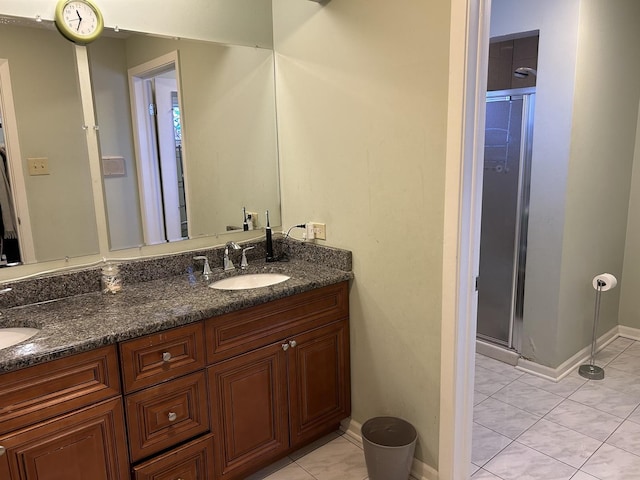 bathroom featuring vanity, tile patterned floors, and walk in shower