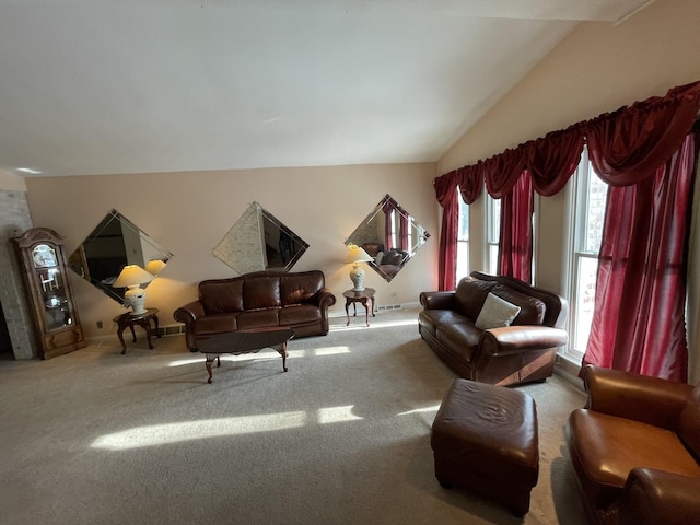 carpeted living room featuring vaulted ceiling and plenty of natural light