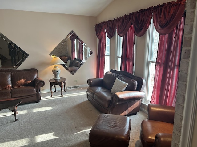 living room featuring lofted ceiling and carpet floors