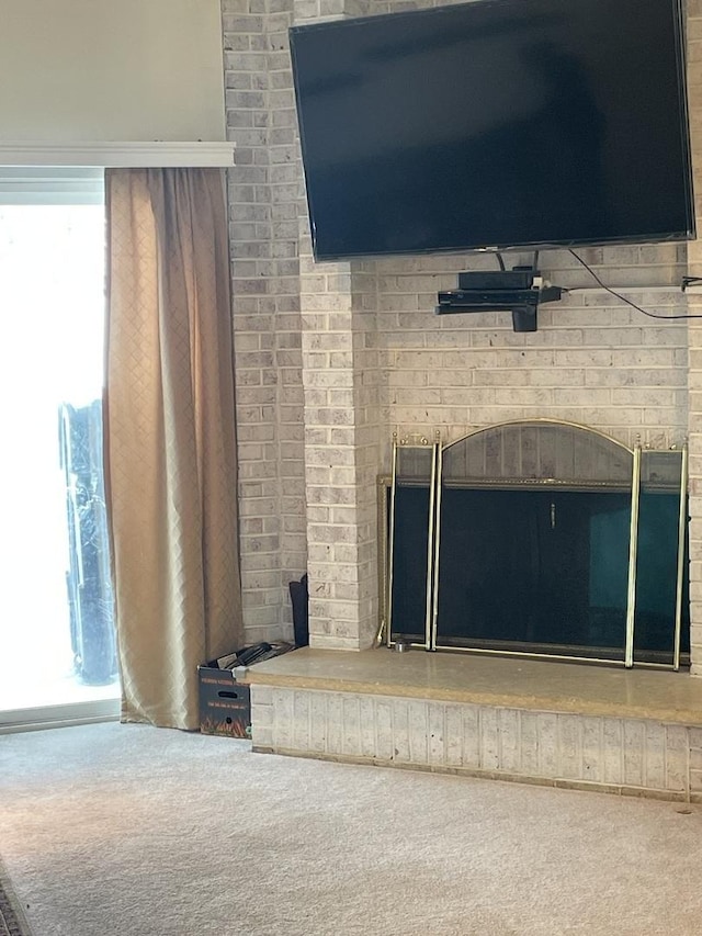 interior details featuring a fireplace and carpet