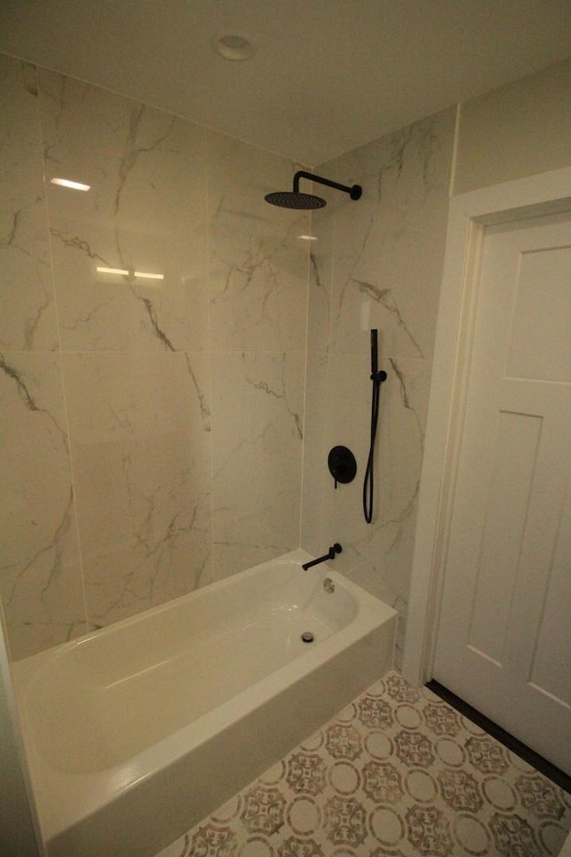 bathroom with tiled shower / bath combo and tile patterned floors