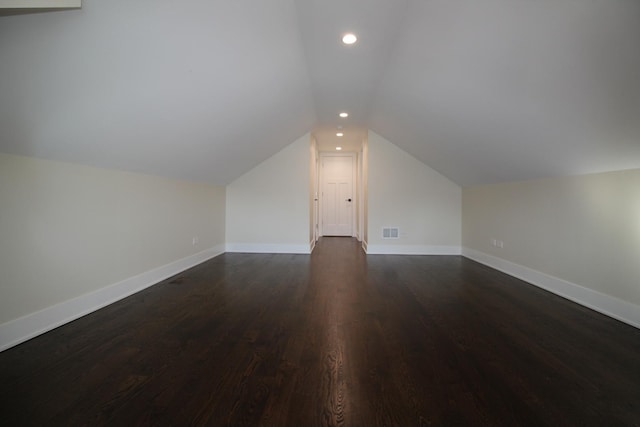 bonus room with dark hardwood / wood-style flooring and lofted ceiling