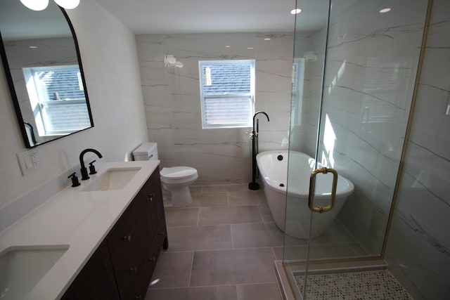 bathroom featuring a wealth of natural light, tile patterned floors, vanity, and separate shower and tub