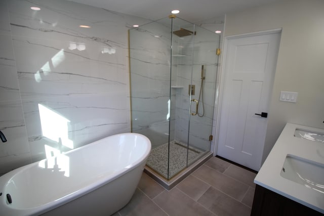 bathroom with tile patterned floors, vanity, and separate shower and tub