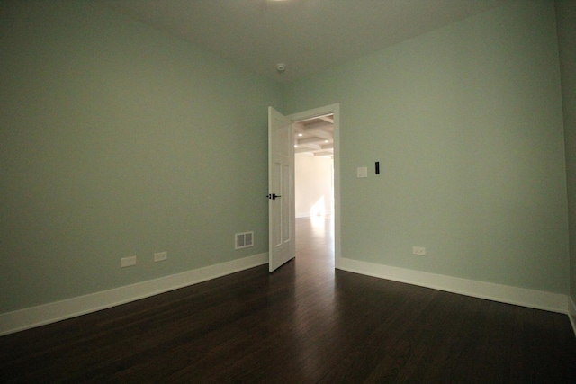 unfurnished room featuring dark wood-type flooring