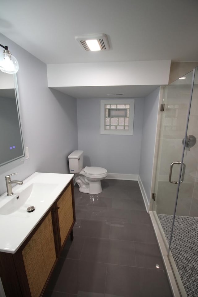 bathroom with tile patterned floors, toilet, a shower with door, and vanity