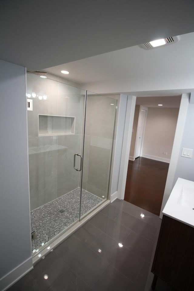 bathroom featuring vanity, tile patterned floors, and an enclosed shower