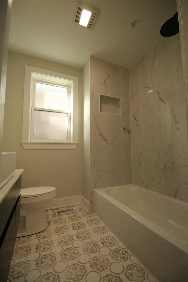 full bathroom with toilet, vanity, and tiled shower / bath combo