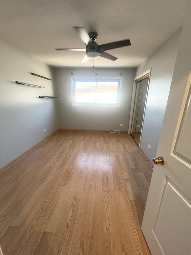 unfurnished bedroom featuring a closet, ceiling fan, and light hardwood / wood-style floors